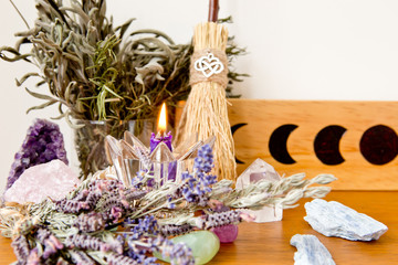 Moon Altar with candles, herbs, witch's  broom and moon phase wooden tile