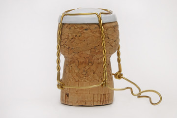 Standing Champagne Cork and Wire Cage Isolated Against a White Background