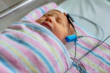 hearing test of a sleeping newborn at hospital
