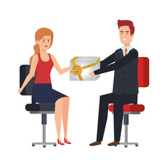 business couple sitting in chairs giving gift