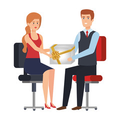business couple sitting in chairs giving gift