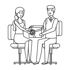business couple sitting in chairs giving gift