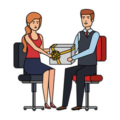 business couple sitting in chairs giving gift