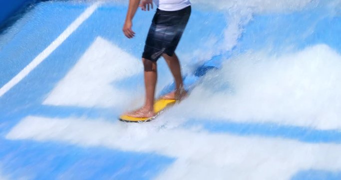 Young man exercising on a surf board during powerful water jet stream in Labadee, Haiti, 4K