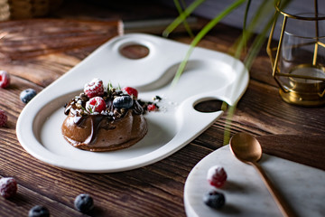 Chocolate cream mousse cake with fresh berries. delicious dessert.