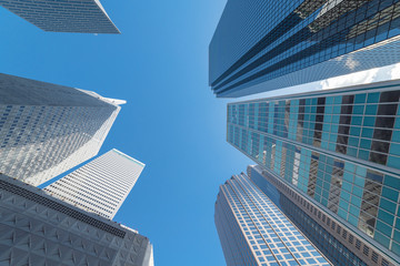 Upward view of skyscrapers against blue sky in the business district area of downtown Dallas, Texas, USA.