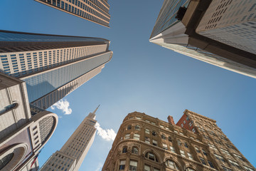 Upward view of skyscrapers against blue sky in the business district area of downtown Dallas,...