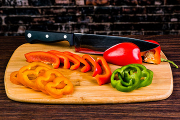 Slicing and chopping colorful Vegetables on a bamboo cutting board with a chef's knife.