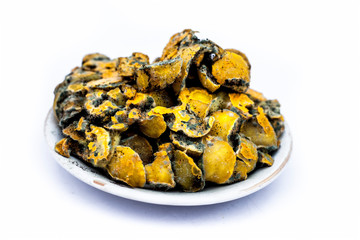 Close up of pickle of Indian gooseberry isolated on white in a glass plate.