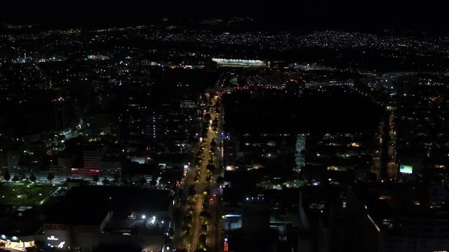 Aerial night panoramic view of Polanco district in Mexico City, drone flying backwards slowly