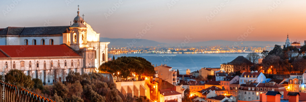 Wall mural bright beautiful night cityscape, night lisbon is the capital of portugal in the heights