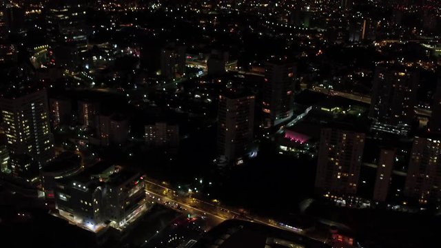 Aerial night panoramic view of Santa Fe district in Mexico City, drone slowlytilting up