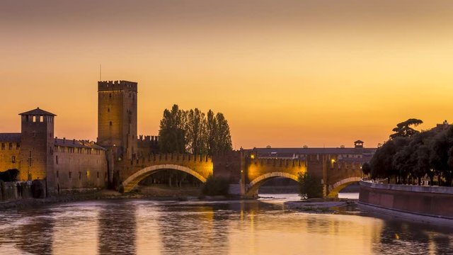 4K footage of The Castel Vecchio Bridge or Scaliger Bridge (Ponte Scaligero) is a fortified bridge in Verona City in Italy, sunset timelapse video day to night. Adige River.