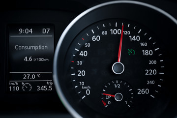 A Modern Car odometer Cluster with LCD Multifunction Display. Meter at constant speed show the fuel consumption efficiency 