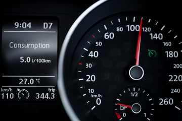 A Modern Car odometer Cluster with LCD Multifunction Display. Meter at constant speed show the fuel...