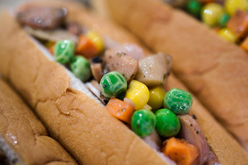 A mixed veggie and meat in a bread