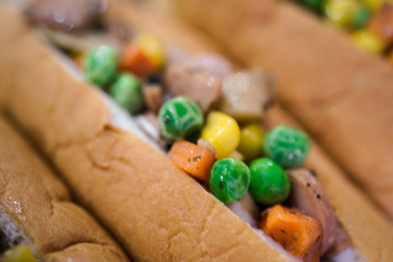 A mixed veggie and meat in a bread