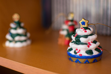 Christmas decoration on wood with more decorations in background