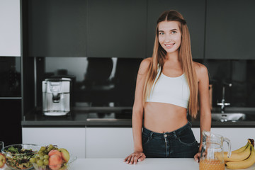 Athletic Girl Stands In Kitchen. Posing Concept.