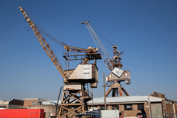 Fototapeta na wymiar Old rusted cranes