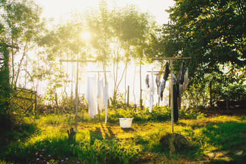 Freshly washed laundry drying on the string outside in the backyard of the farm