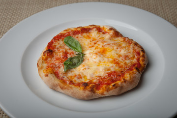 cheese pizza on a white plate