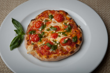 tomatoes pizza on a white plate