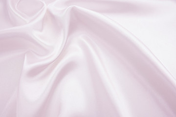 The texture of the satin fabric of pink color for the background