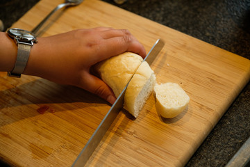 Cutting bread on a wooden board