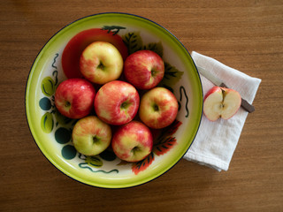 Organic Honeycrisp Apples in a Tin Bowl with a Half Apple and Paring Knife on a Dish Towel