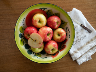 Vintage Painted Tin Bowl with Apples with Dish Towel and Paring Knife from Above