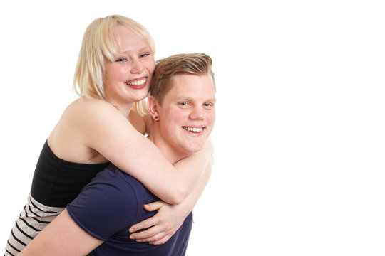  young guy carrying his girlfriend piggyback