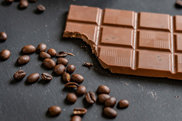 flat lay of bitten chocolate bar on dark surface f