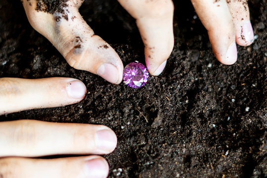 Searcher Hands Holding A Diamond In The Soil Ground F