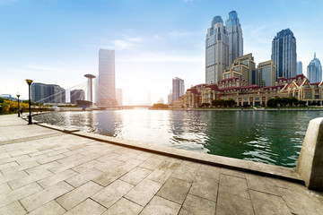 empty tiled floor and urban skyline,tianjin china.
