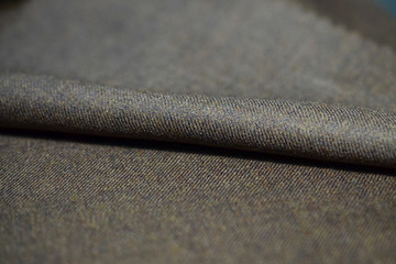 close up role brown fabric of suit