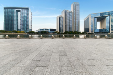 empty tiled floor and urban skyline,tianjin china.