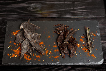 Processed jerky on black stone board