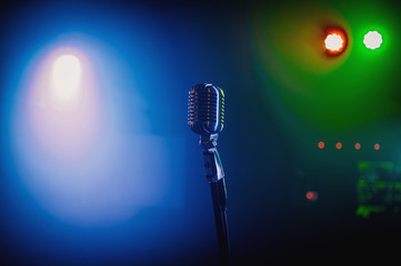 Retro microphone on stage in a pub or American Bar(restaurant) during a night show.