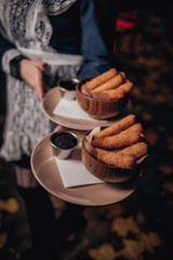 sticks in batter in the hand of the waiter