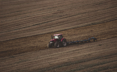 Single tractor preparing land for sowing