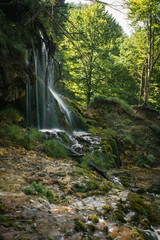 Small mountain waterfall deep in the oak forest