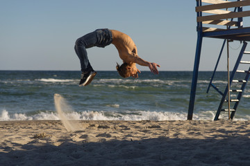 young man jump on the sea