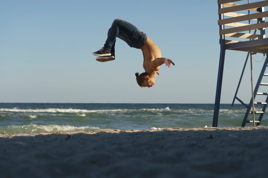 Freedom and creativity, man flipping on the beach