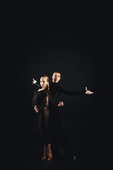 Beauty, fashion. Dancing over black background, beautiful couple of ballet dancers