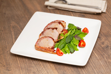 Roasted Pork Tenderloin Wrapped in bacon with lettuce and tomatoes