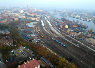 Aerial view on urban area with main train station close to big river.
