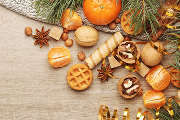 Still life composition formed with pine branches and New Year sweets	