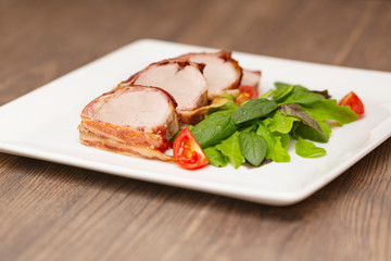 Roasted Pork Tenderloin Wrapped in bacon with lettuce and tomatoes