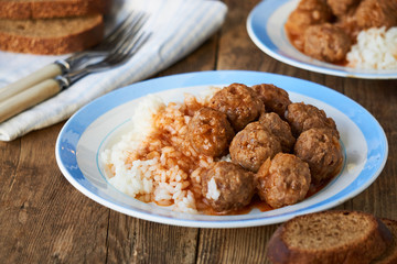 Meatballs with tomato sauce and rice on a plate